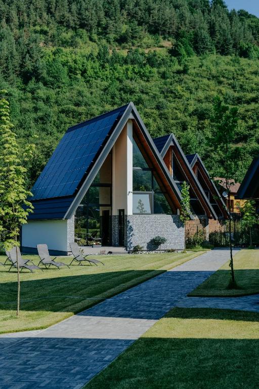 a house with solar panels on the roof at Diamond Hill Houses in Praid
