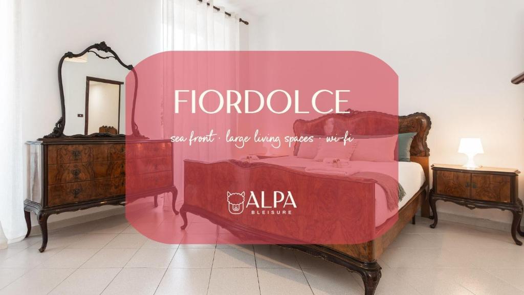 a large pink bed in a room with a mirror at "Fiordolce" a due passi dal mare in Vado Ligure