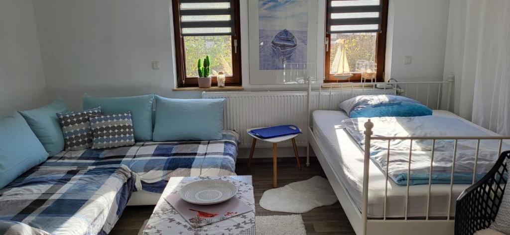 a room with two beds and a couch and a table at Ferienhaus Deubetal Nr.10 in Stadtilm
