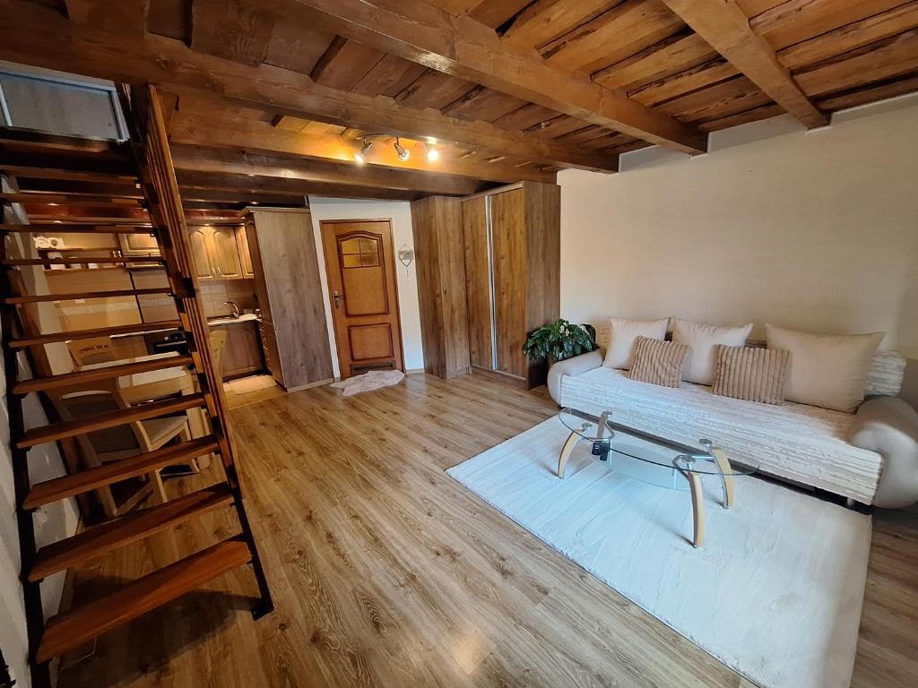a living room with a couch and a staircase at Apartmán Bianka in Rabča