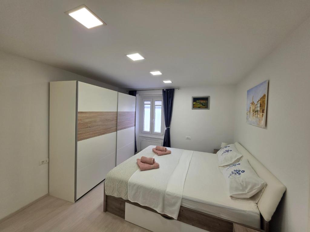 a bedroom with a bed with two pink towels on it at Breece Hideaway in Piran