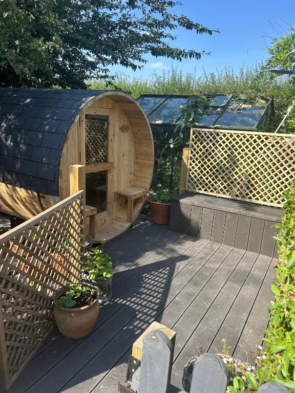a wooden deck with a dog house on it at Bridleway Bed & Breakfast in Lincoln