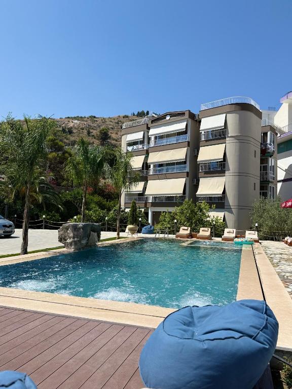 a large swimming pool in front of a building at Vila Marjana in Sarandë