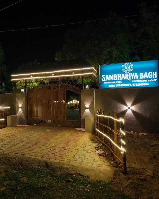 a building with a gate and a sign at night at Sambhariya Bagh Resort in Kānota