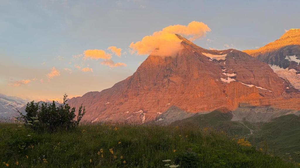a mountain with smoke coming out of it at Stöcki-Grindelwaldblick in Kleine Scheidegg