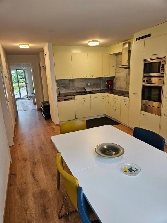 a kitchen with a white table and chairs at Ferienwohnung Sesvenna Davos in Davos
