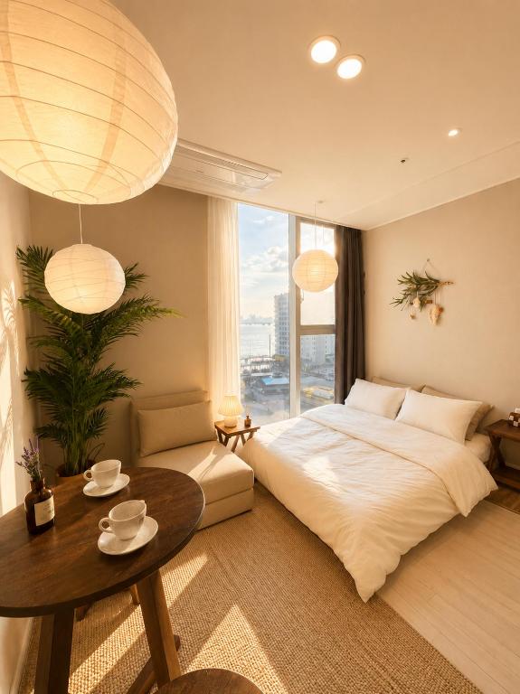 a bedroom with a large bed and a table at Mood-Ocean 영종도 오션파크나인호텔 in Chagyak-to