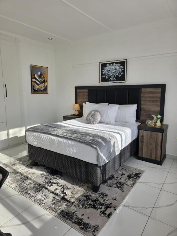 a bedroom with a large bed in a room at Flourish Haven Escape in Germiston