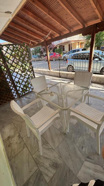 a white table and two chairs on a patio at Olimpik bic in Paralia Katerinis