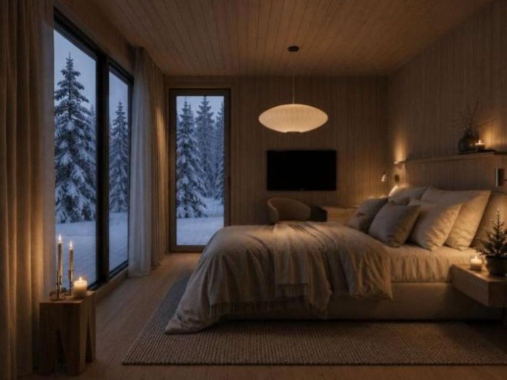 a bedroom with a large bed and a large window at Villa Virpi in Rovaniemi