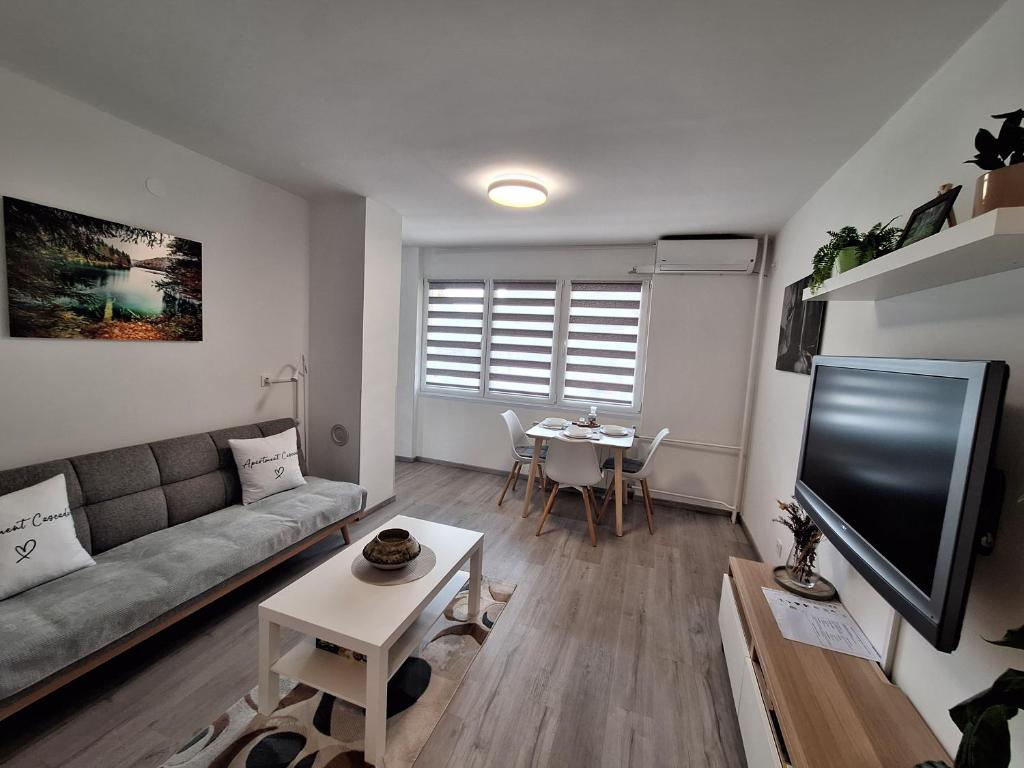 a living room with a couch and a table at Studio apartment Cascada in Plitvička Jezera