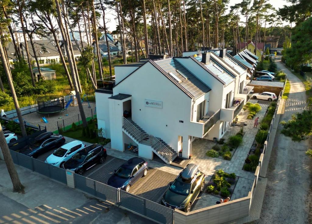an aerial view of a house with cars parked outside at Apartamenty Marco Polo in Dziwnówek