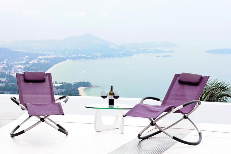 two purple chairs and a table with a bottle of wine at Best world vision in Chaweng