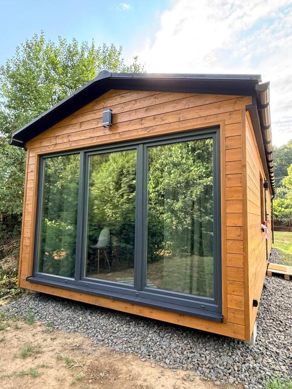 a cabin with a large glass window in a yard at Ubytovanie Lišov 3 - Tiny House in Lišov