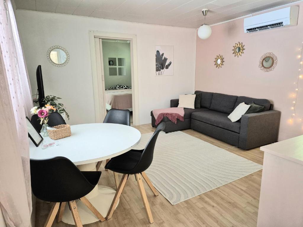 a living room with a table and a couch at Solmula in Keuruu