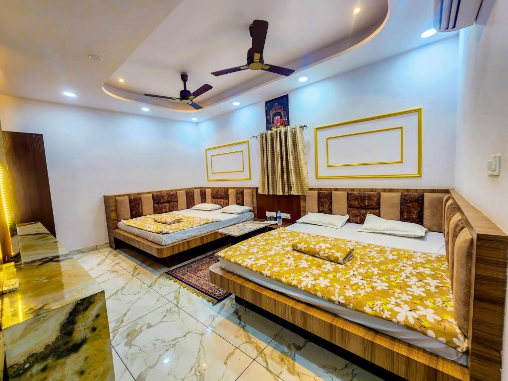 a bedroom with two beds in a room at Hotel Shree Karni Palace in Deshnoke