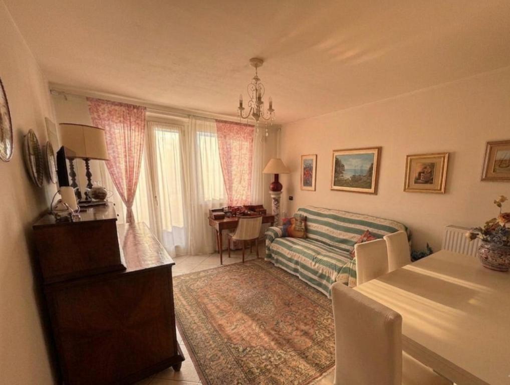 a living room with a couch and a table at Casa di Paola Spormaggiore in Spormaggiore