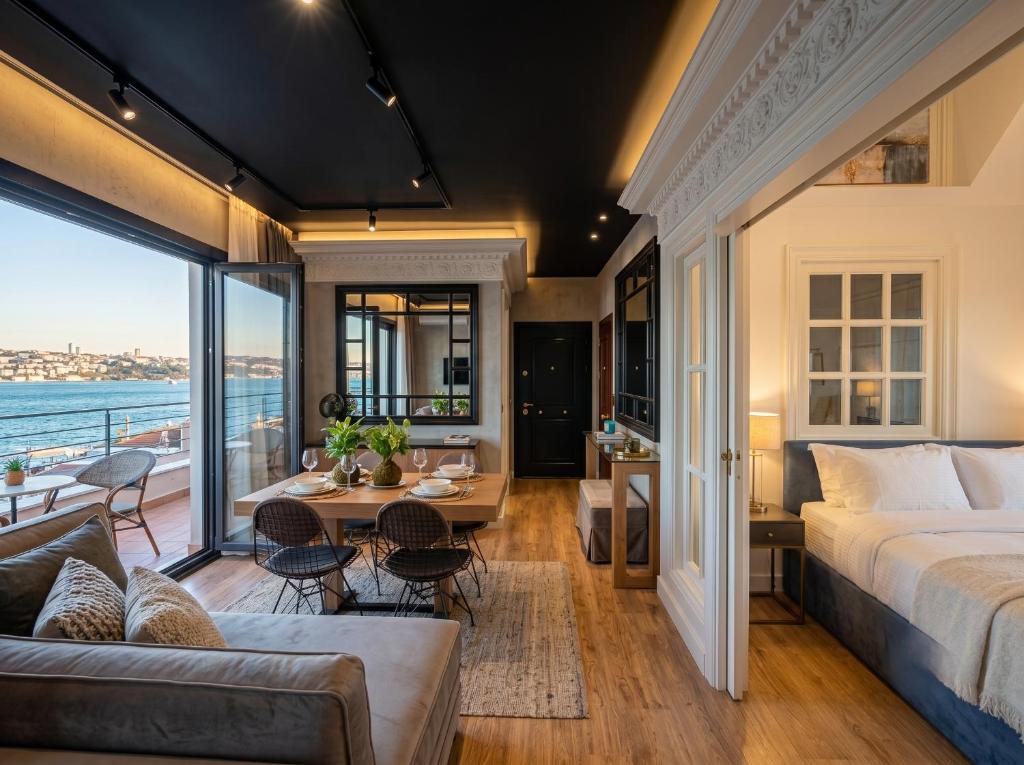a bedroom with a bed and a living room at Alfred Promenade Apartments in Sarandë