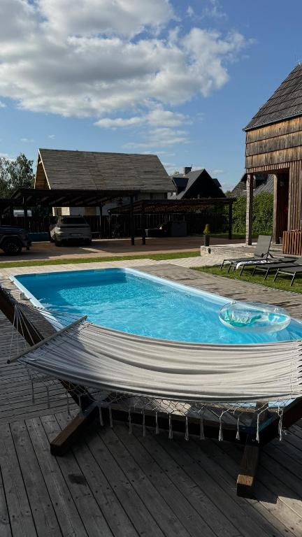 a large blue swimming pool sitting on top of a deck at Rydzewo Resort in Rydzewo