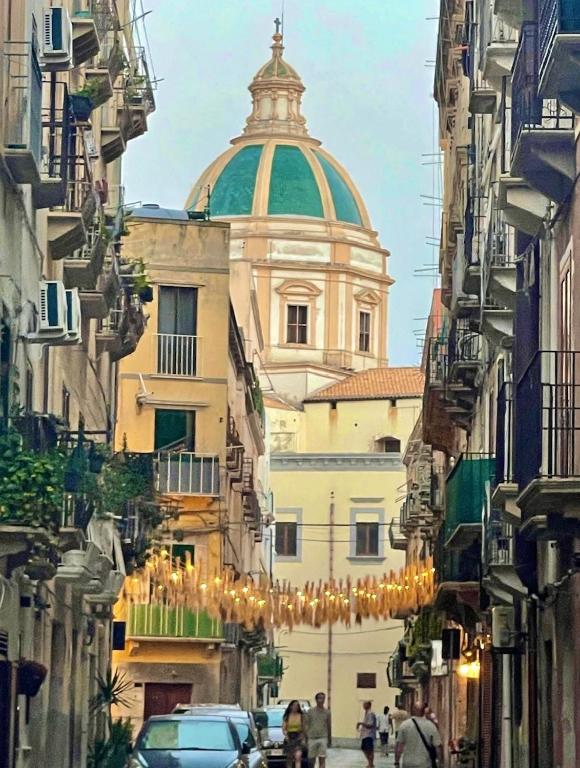 a building with a dome on top of a street at La Gorgonia in Trapani