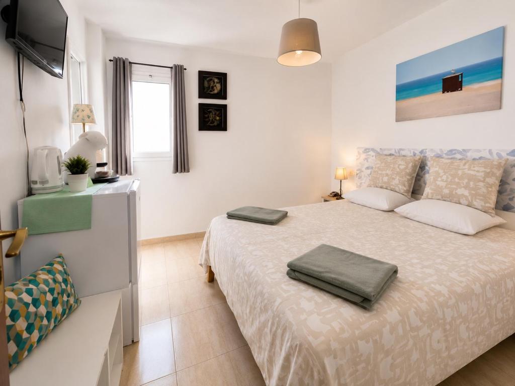 a bedroom with a large bed with two pillows on it at MiVida in San Bartolomé