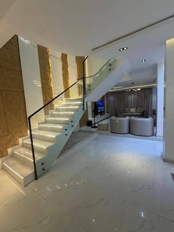 a staircase in a building with a lobby at Xclusive Luxury Apt in Mopo Onijebu
