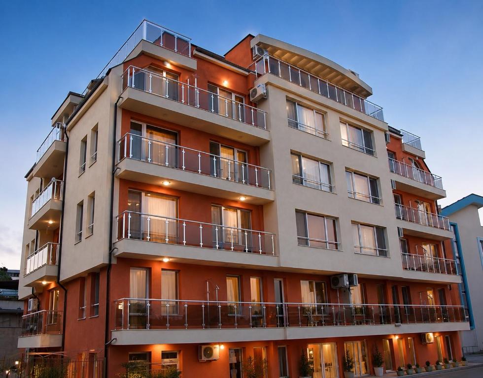 a building with balconies on the side of it at Hotel Topalovi in Nesebar