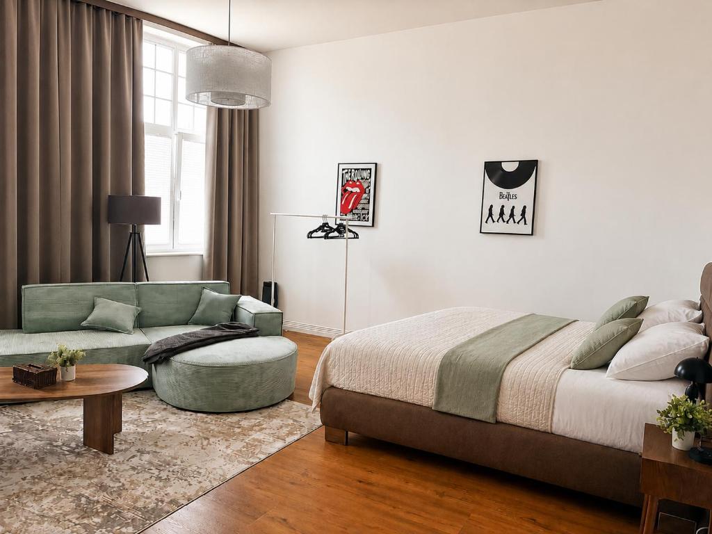 a bedroom with a bed and a couch and a table at Schängel Chic 16 in Koblenz