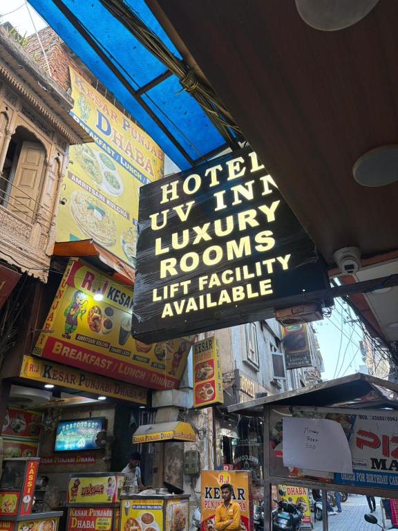 a sign for a hotel in aatownatownolis lift facility available at Hotel U V 2 mins from golden temple in Amritsar