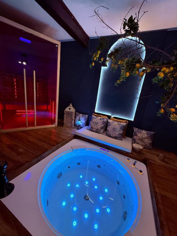 a room with a large blue tub in the middle at Ama Collection Esclusive Spa Ariosto in Ferrara