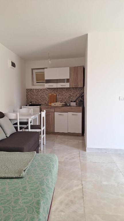 a living room and kitchen with a couch and a table at Coco 2 free parking in Pržno