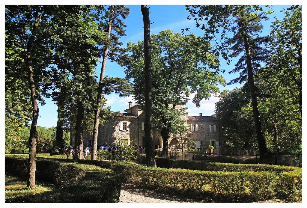 a house in the middle of a park with trees at Domaine de Saint Charles in Les Plans