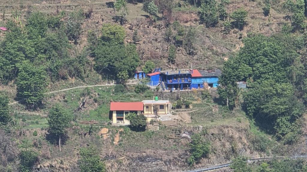a house sitting on top of a hill at Dhankeshwar Dham Homestay in Champawat