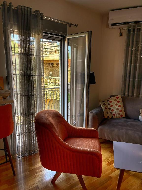 a living room with a chair and a couch at L&K Old Town Apartment in Podgorica
