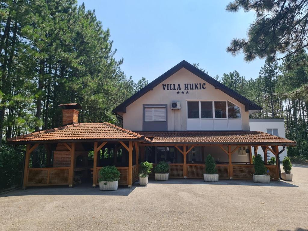 a villa house with a pavilion in front of it at Villa Hukic in Tuzla
