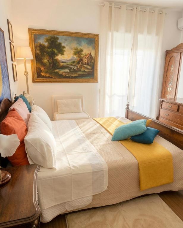 a bedroom with a large bed with pillows on it at Suite Ekaterina Sunsets 2 minuti dal mare in Brolo