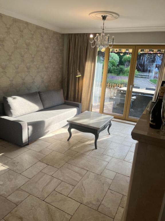 a living room with a couch and a coffee table at Willa Oliwa in Gdańsk
