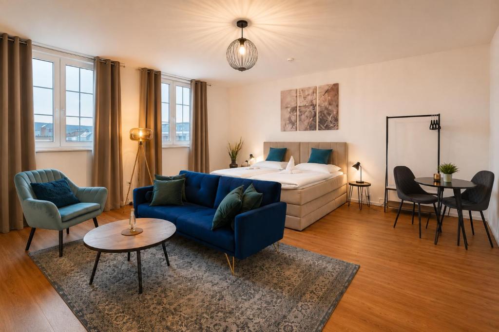 a living room with a bed and a blue couch at Schängel Chic 19 in Koblenz