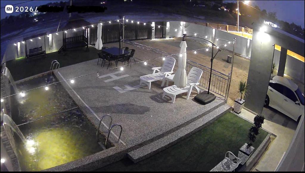 an aerial view of a patio with chairs and a table at Farisya Homestay in Kota Bharu