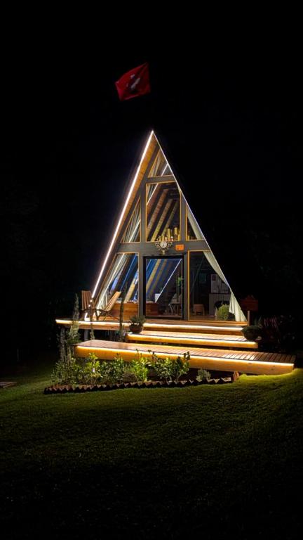 a house with a flag on top of it at night at Cabana Refúgio Barn in Caxias do Sul
