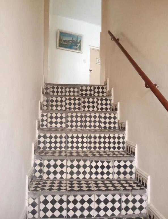 a staircase with a black and white checkered floor at Maison Traditionnelle in Casablanca