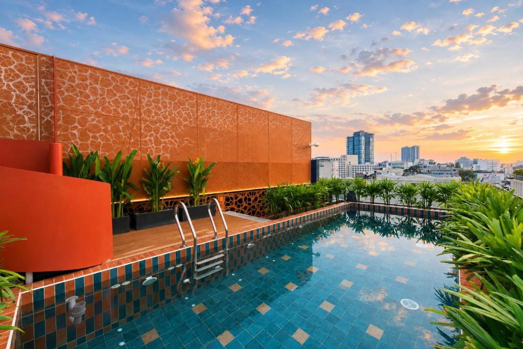 a swimming pool on the roof of a building at KiN Hotel Ly Tu Trong Edition in Ho Chi Minh City
