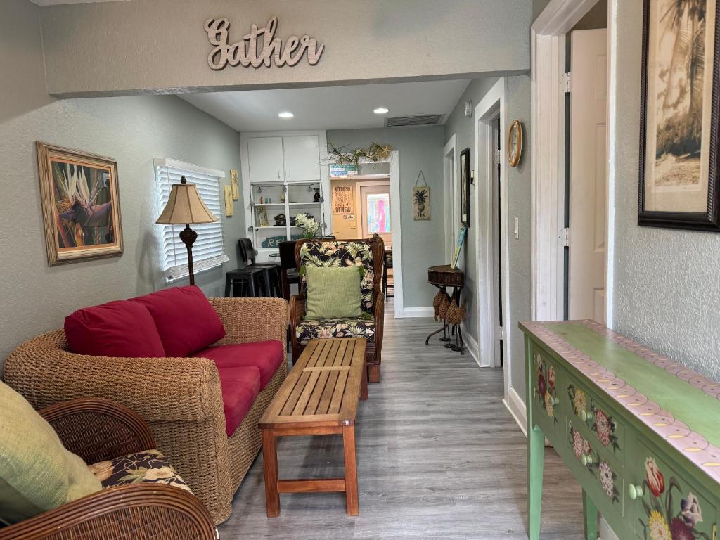a living room with a couch and a table at Mango Beach House in Lake Worth