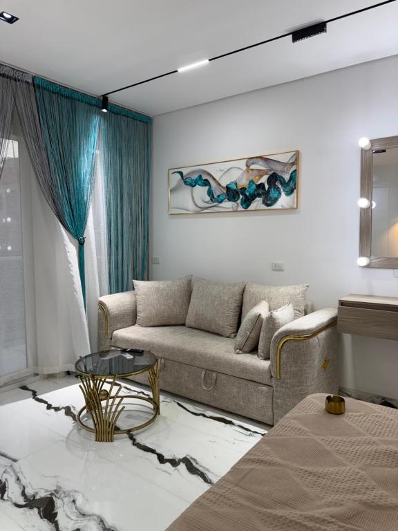 a living room with a couch and a table at Jasmine Studio Sharm El Sheikh in Dawwār Ruḩayyim
