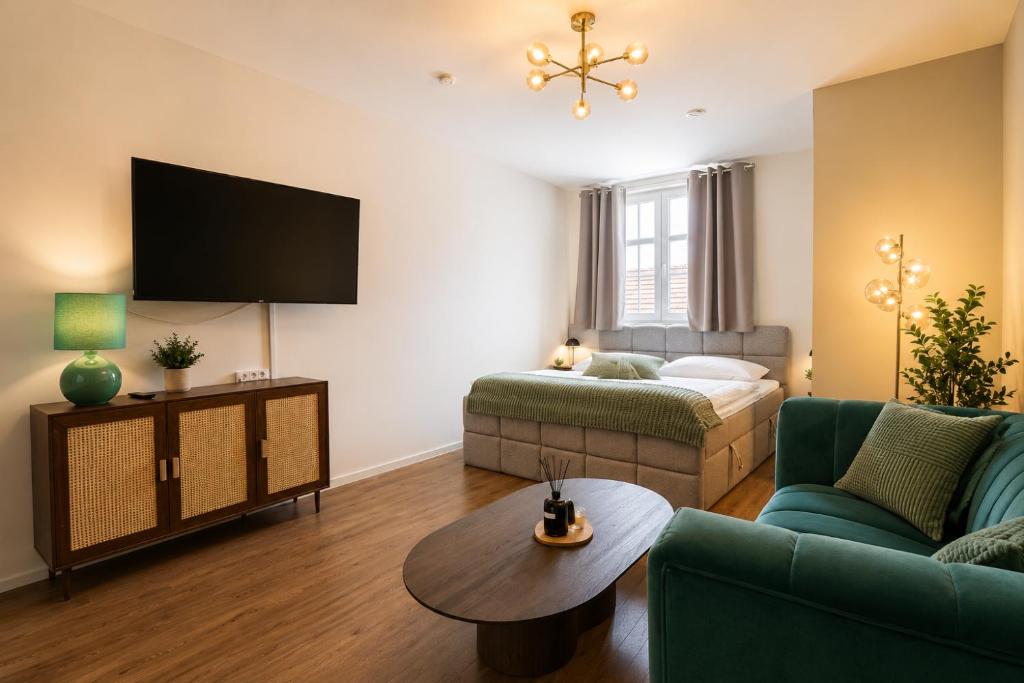 a living room with a couch and a bed at Schängel Chic 26 in Koblenz