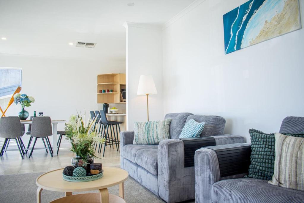 a living room with a couch and a table at Beachfront Getaway Pet-Friendly & Near Boat Ramp - Koala Stay in Encounter Bay