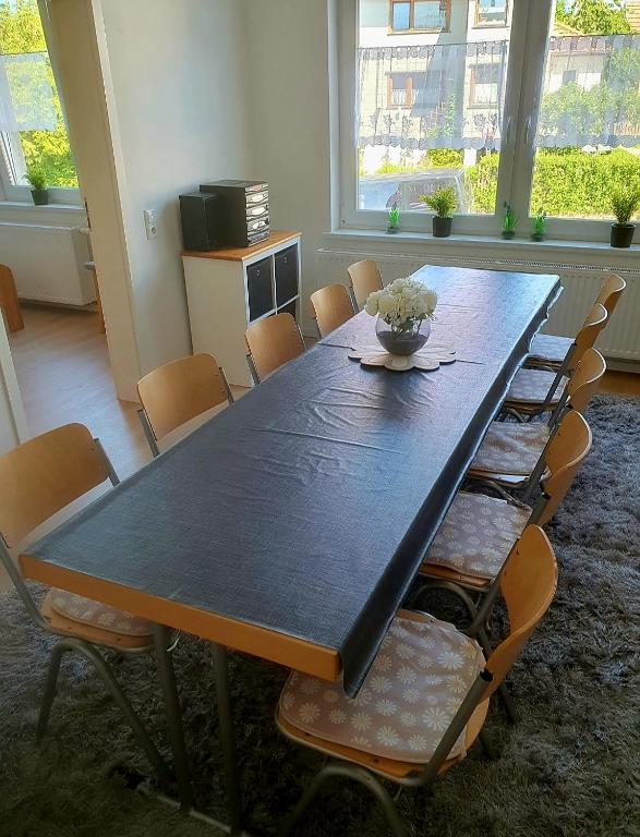a dining room table with chairs and a bowl on it at Monteurwohnung Haus Sendberg Blick in Frielendorf