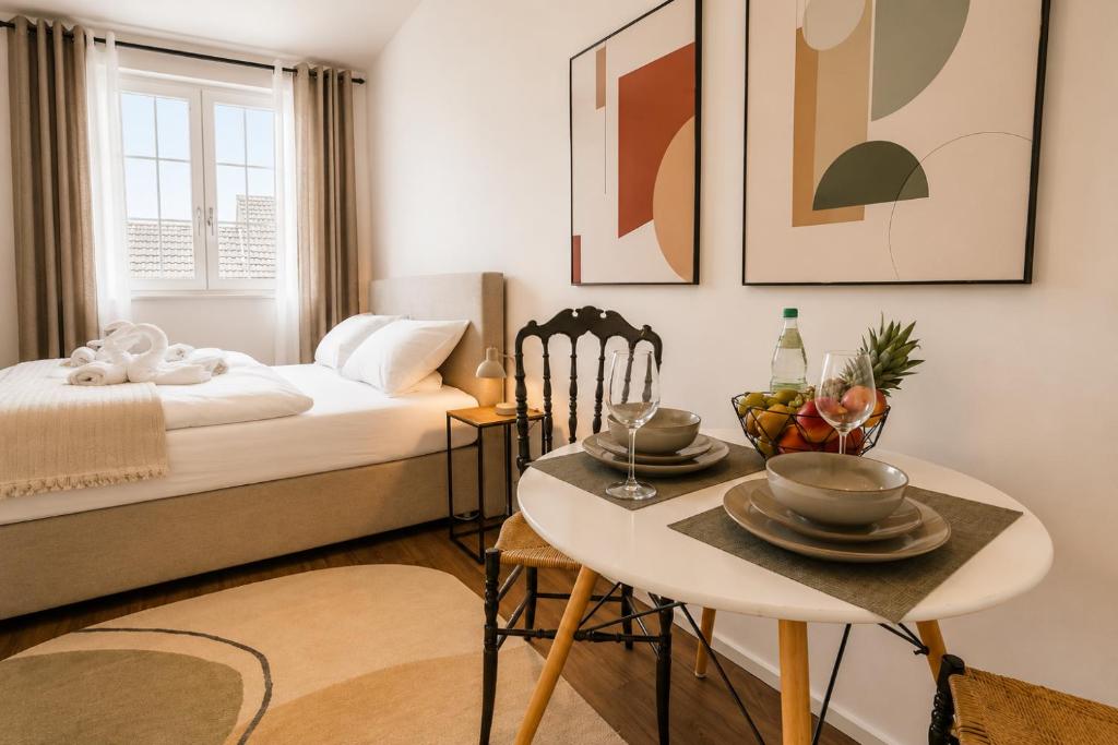 a bedroom with a bed and a table with a bowl of fruit on it at Schängel Chic 27 in Koblenz