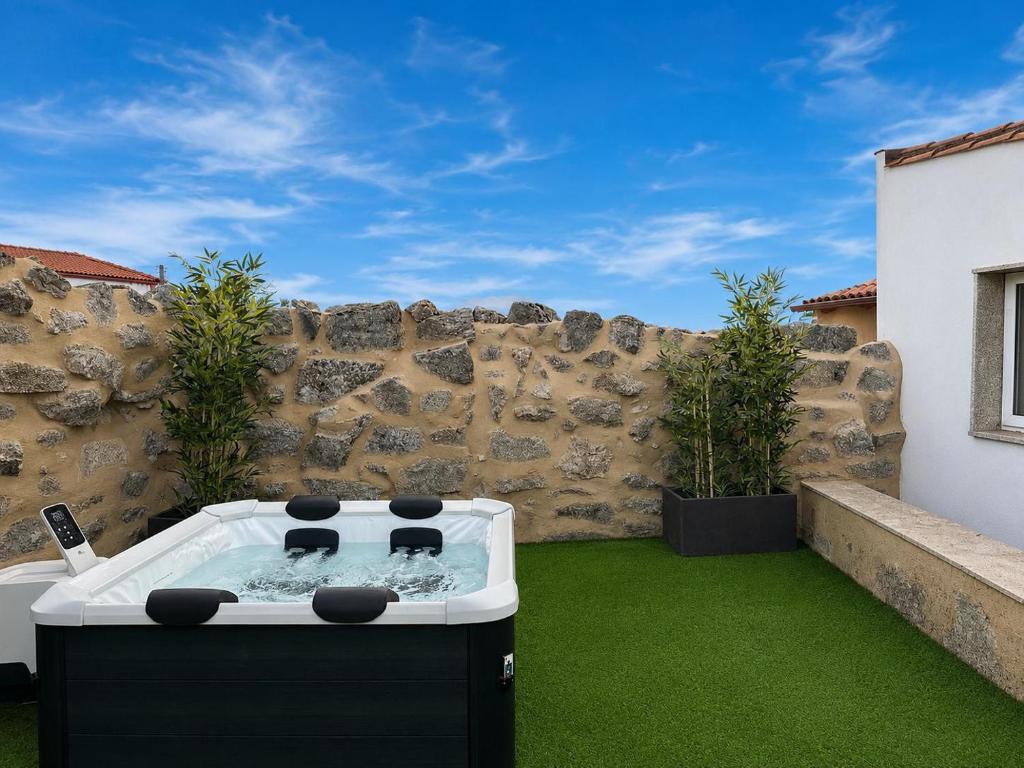 a hot tub in a yard with green grass at YourHouse O Canton 3 in Lobios
