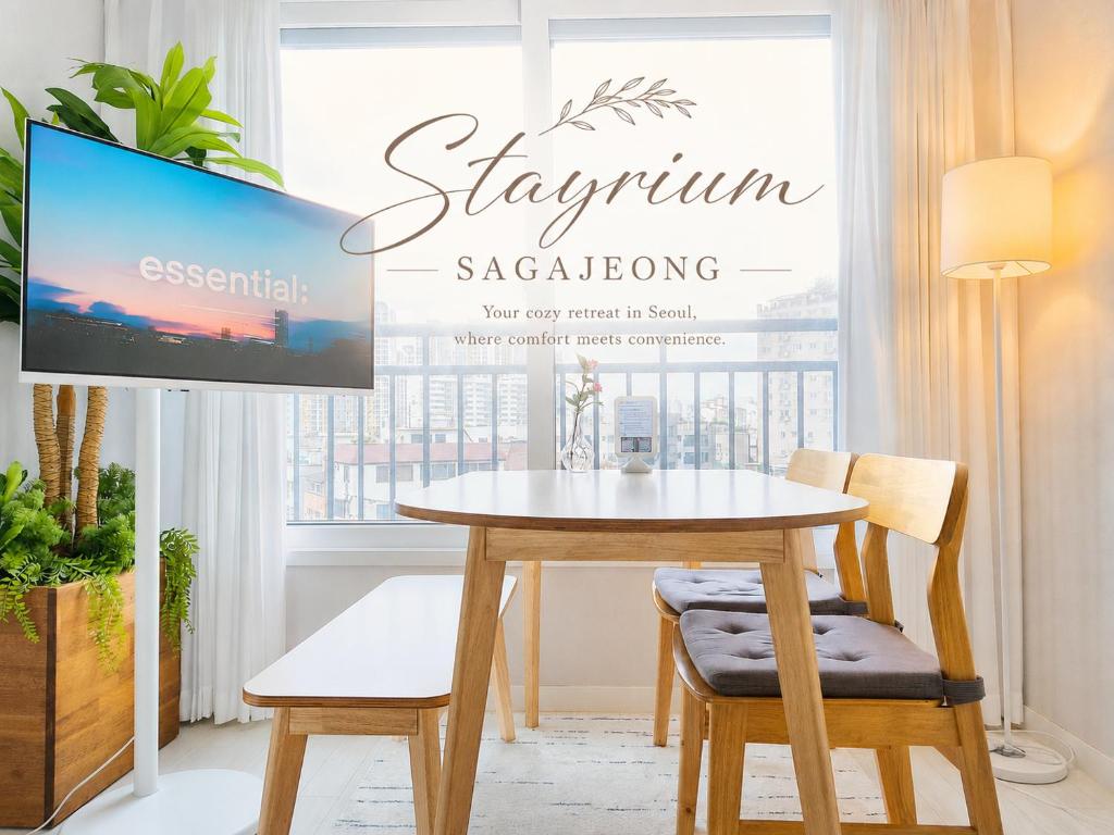 a dining room with a table and a tv at Stayrium Sagajeong in Seoul